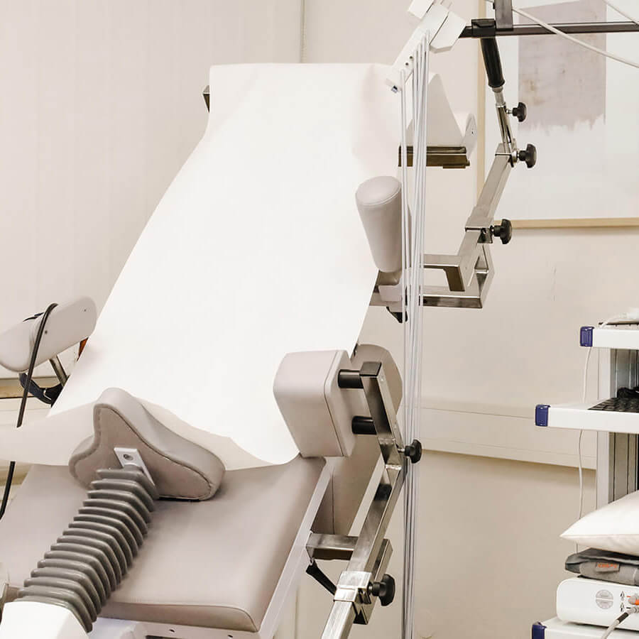 Modern ausgestatteter Untersuchungsraum mit Patientenplatz, EKG- Kabelsystem und Computerarbeitsplatz